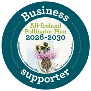 Business supporter logo for the All-Ireland Pollinator Plan 2026 - 2030. Image of bee pollinating on a flower in the middle and teal border with white writing around. Sustainable Tourism Network.